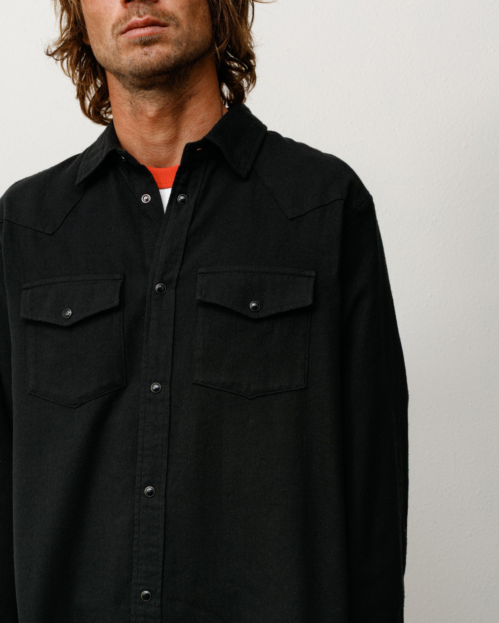 Black cotton-silk Western shirt on model with snap front and dual flap chest pockets
