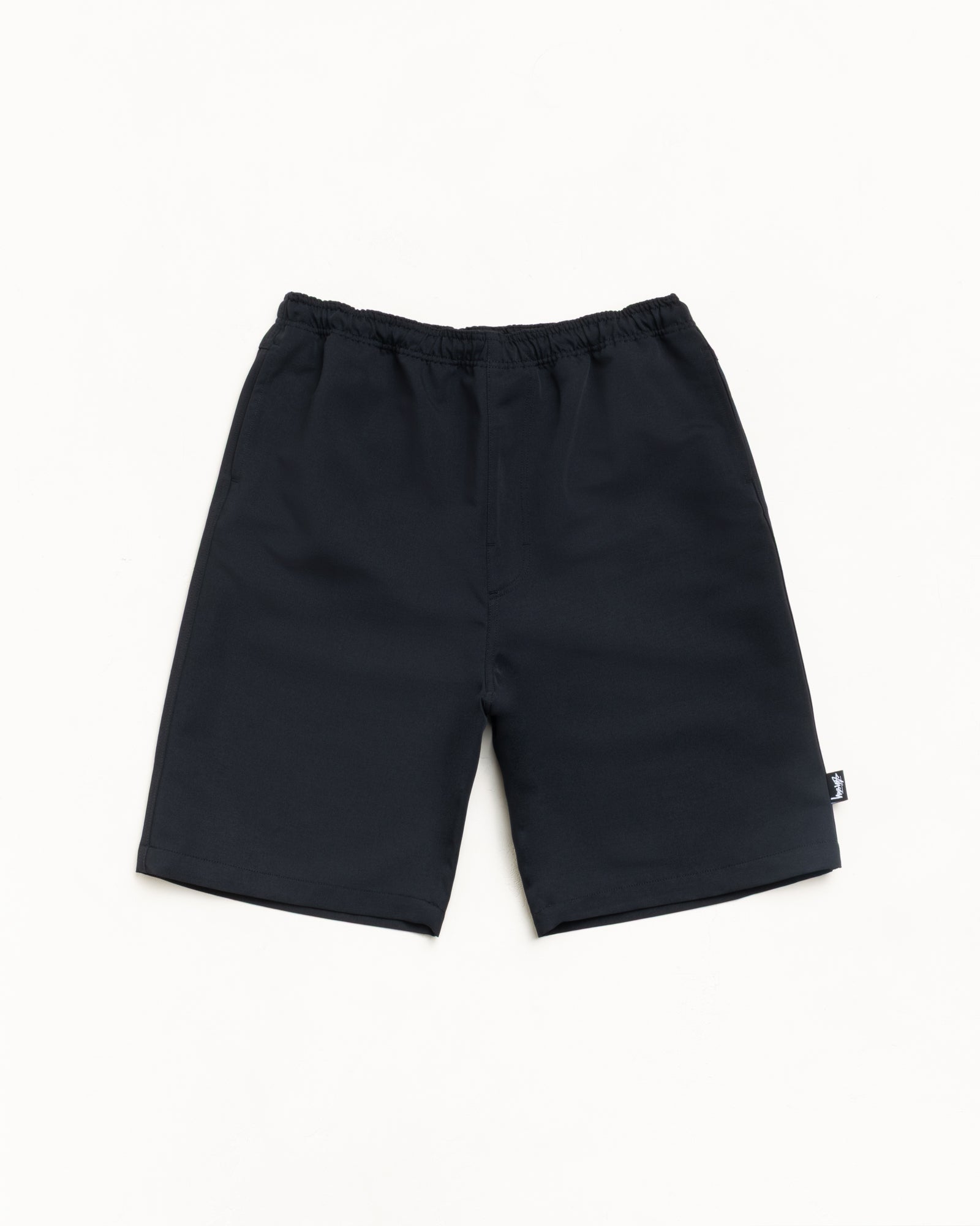Black baggy beach shorts with elastic waist and side pockets, unisex regular fit.