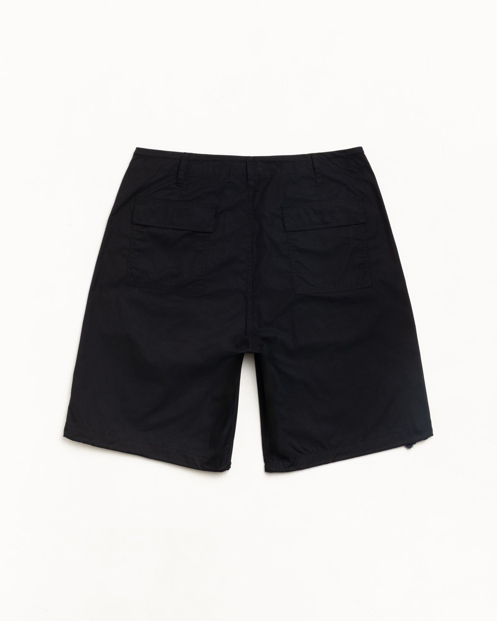 Black surplus short, back view with dual flap pockets, flat lay on white