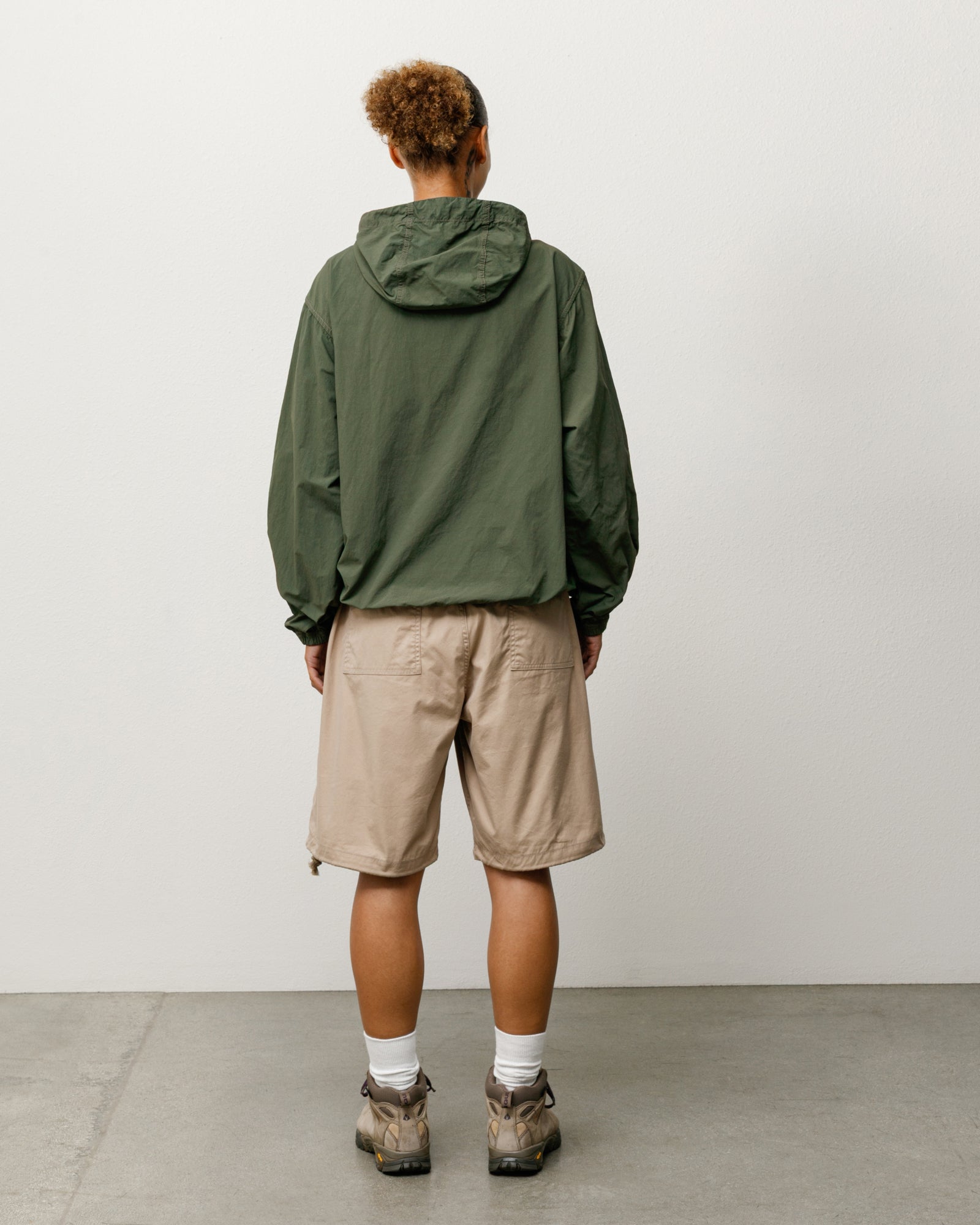 Khaki Surplus Short, unisex regular fit, shown on model from back with adjustable hem.