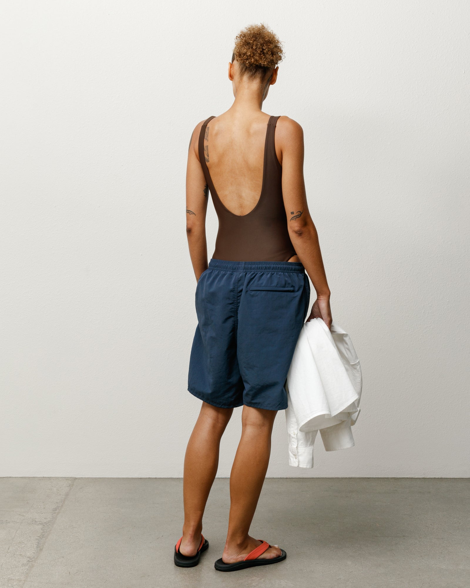 Surf Stock One Piece Swimsuit Womens Regular in the color Brown, featuring a scooped back and blue shorts.