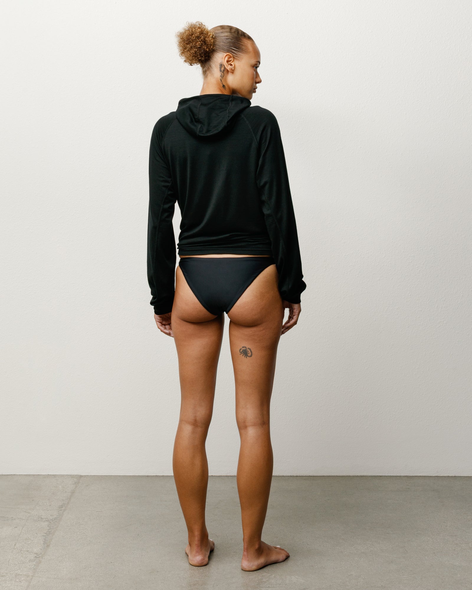 Bikini Bottom Swim in the colour Black featuring a mid-rise waist and Stüssy branding.