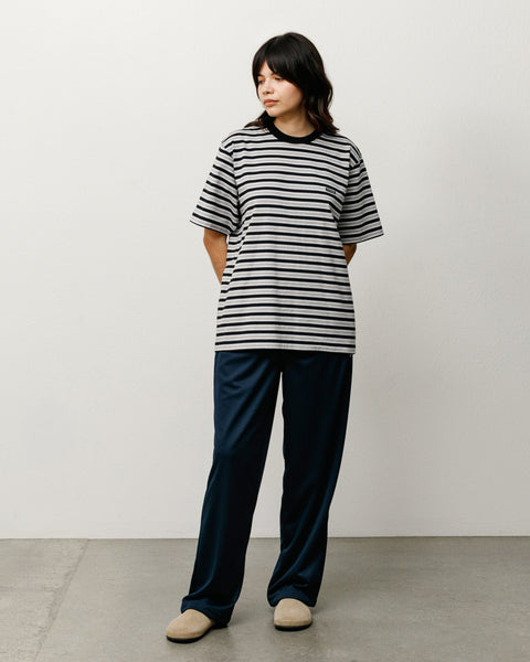 Black and grey striped cotton tee with ribbed crewneck, relaxed fit on model