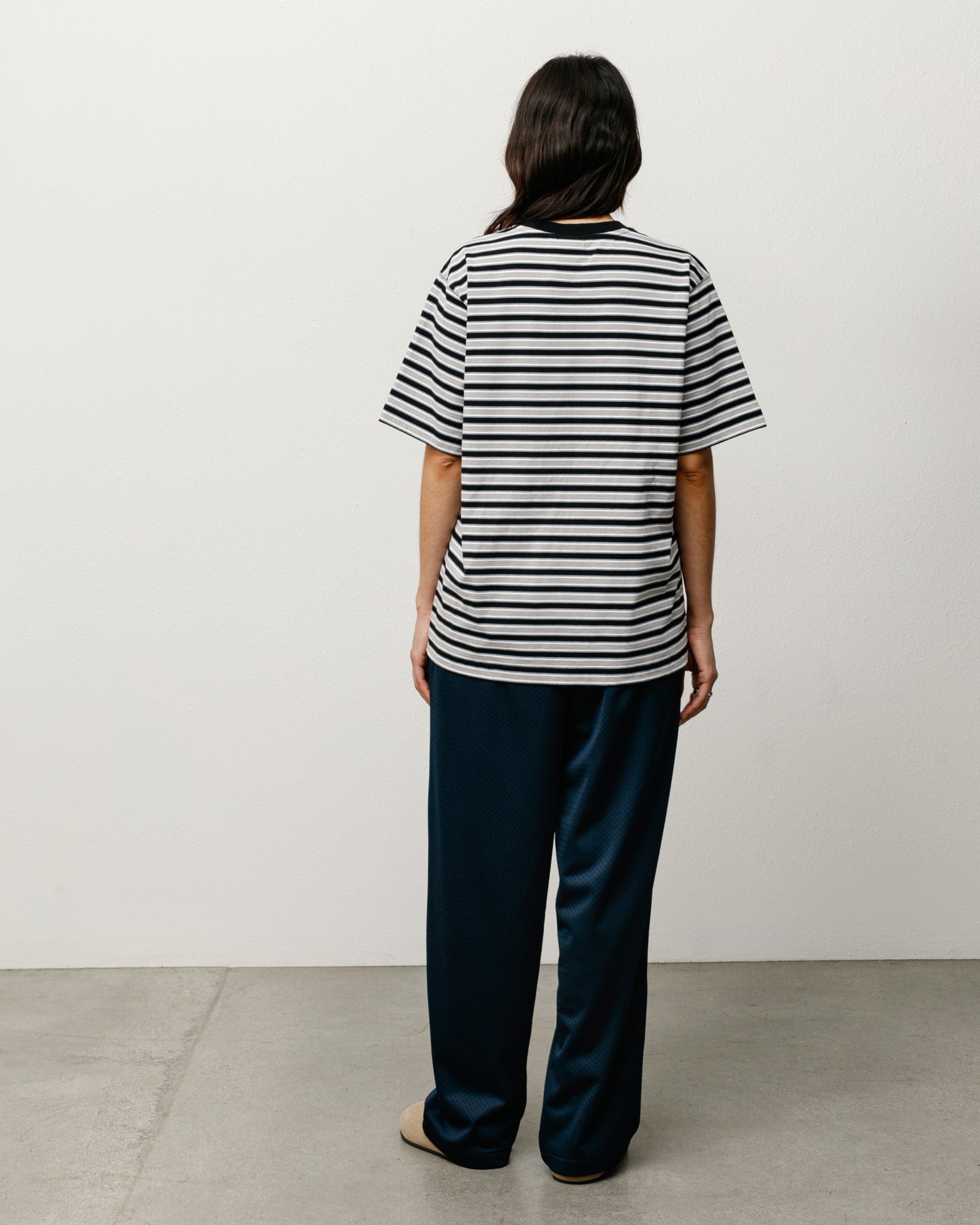 Black-and-white striped crewneck tee, back view on model.