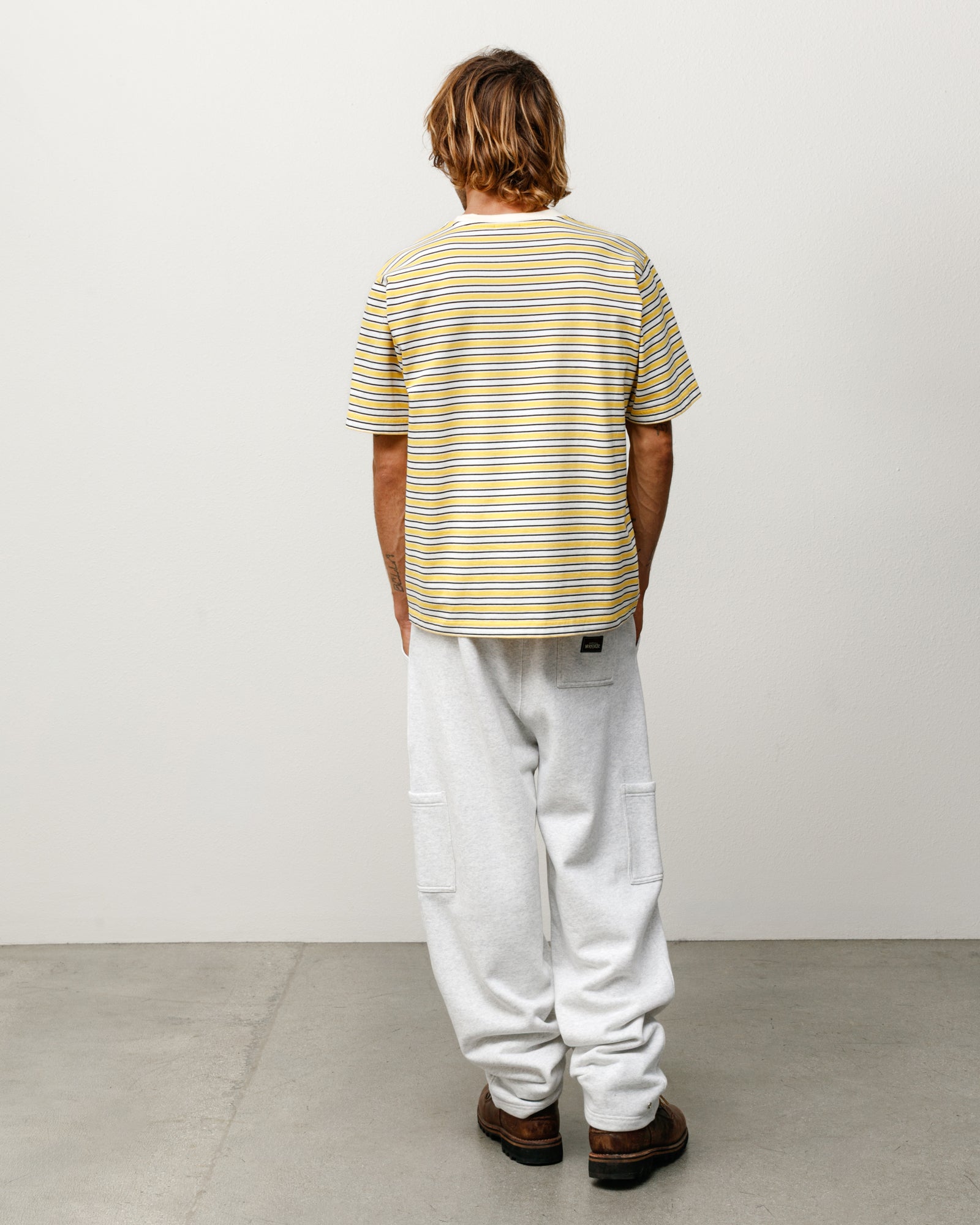 Beach Stripe short-sleeve tee in yellow, back view on model.