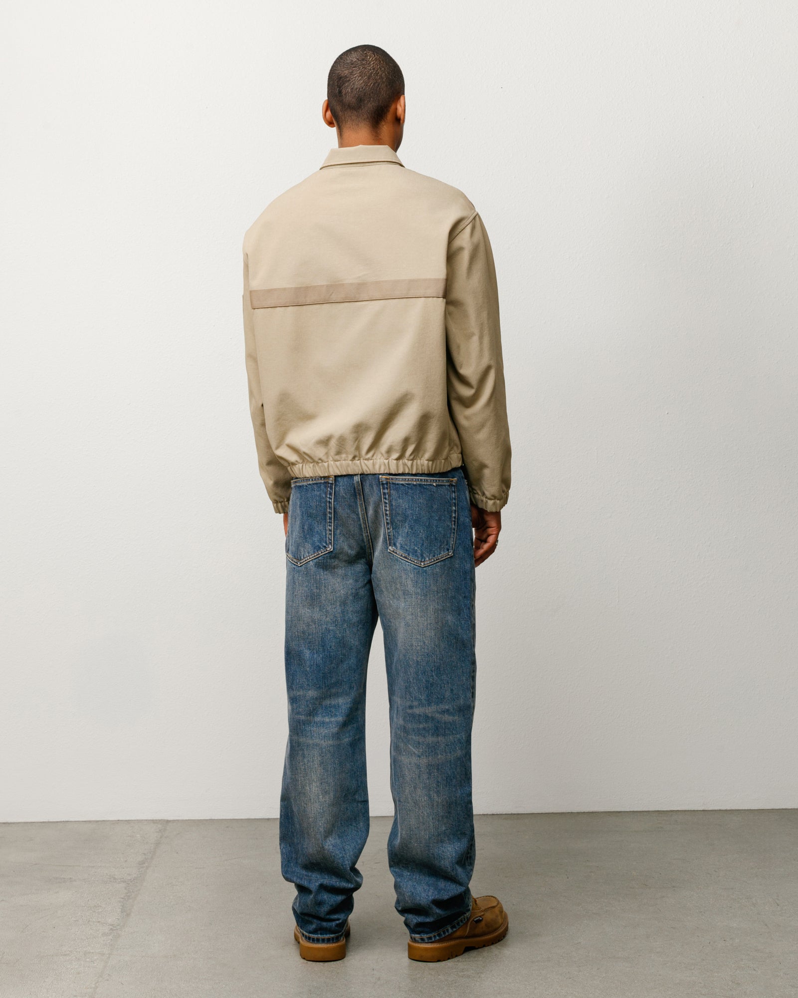 Khaki mechanic jacket, long-sleeve back view showing horizontal webbing stripe and elastic hem