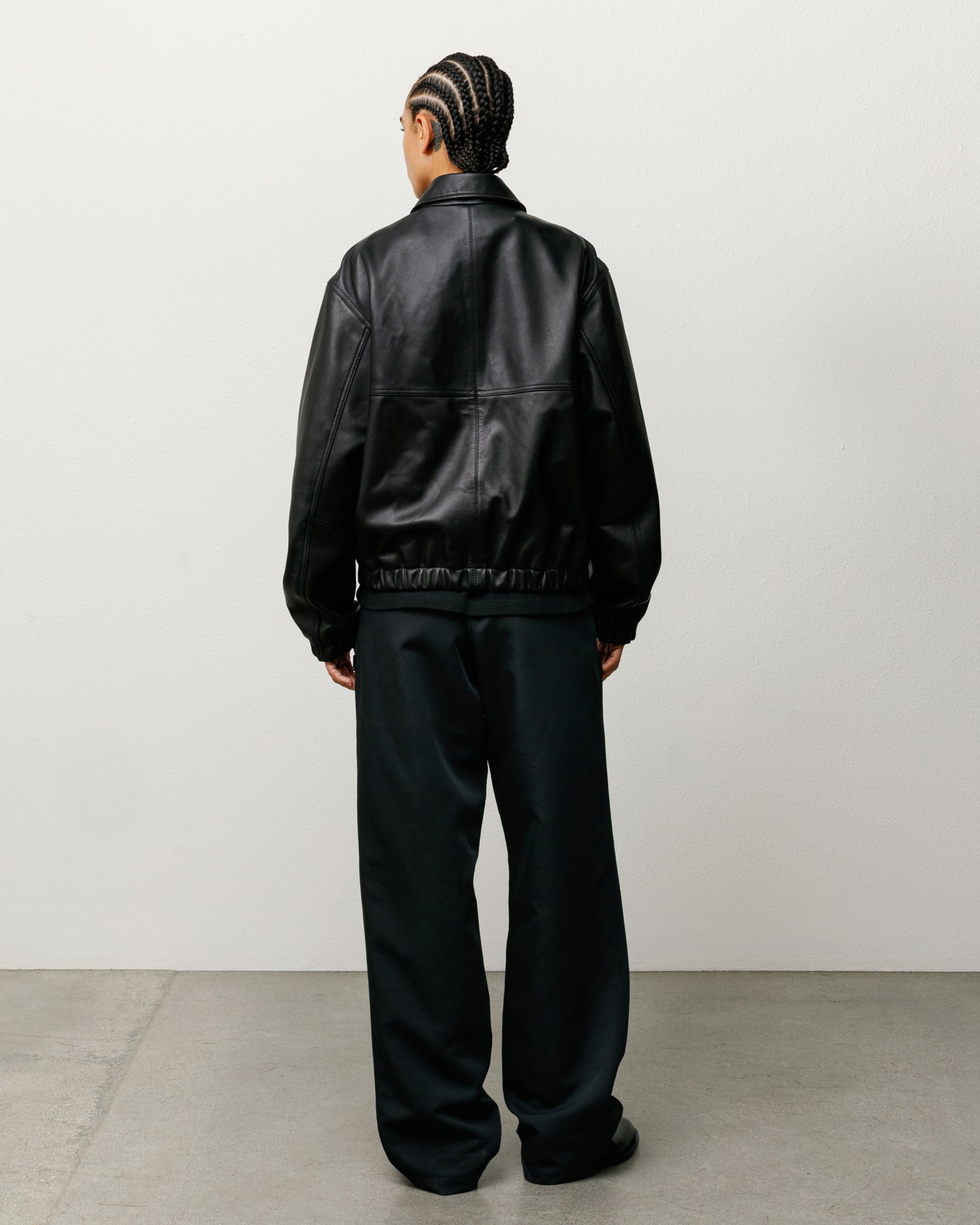 Leather Work Jacket Unisex Back View On Model In Black with Elastic Hem and Relaxed Fit
