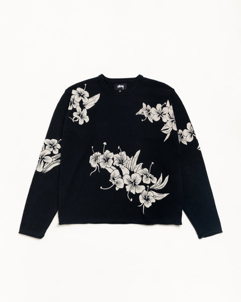Black knit crewneck sweater with white floral pattern and long sleeves