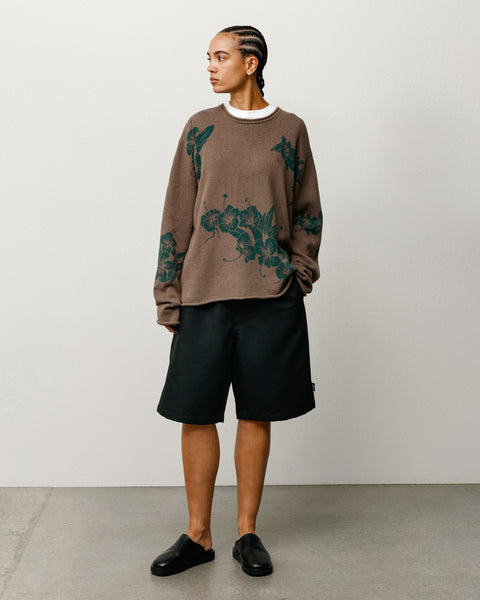 Brown floral knit sweater with rolled crewneck and hem, relaxed fit on model