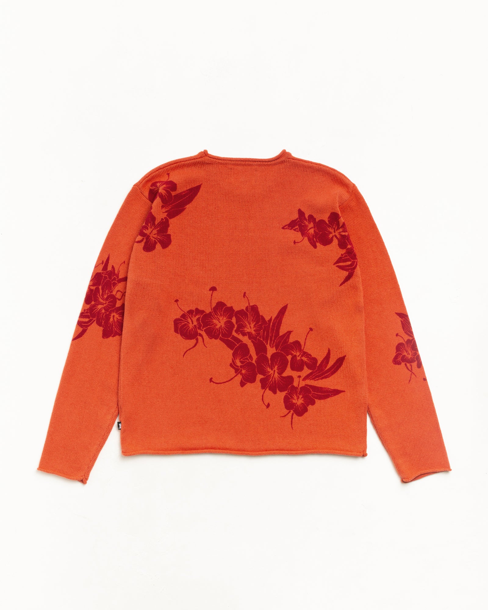 Rust roll-neck sweater, back flat lay with red floral jacquard knit and rolled edges.