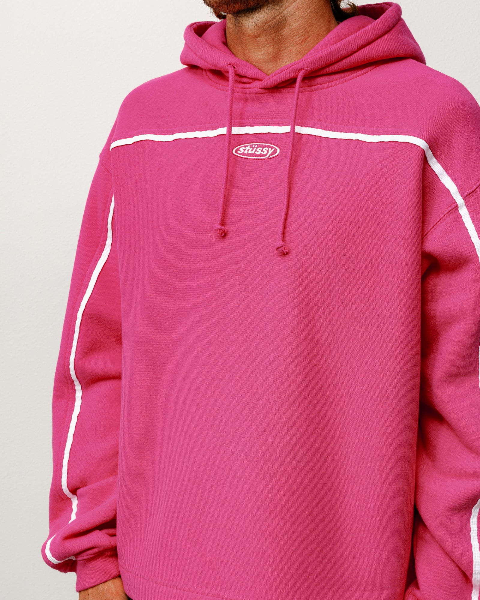 Pink oval pullover hoodie with white contrast piping and chest logo embroidery