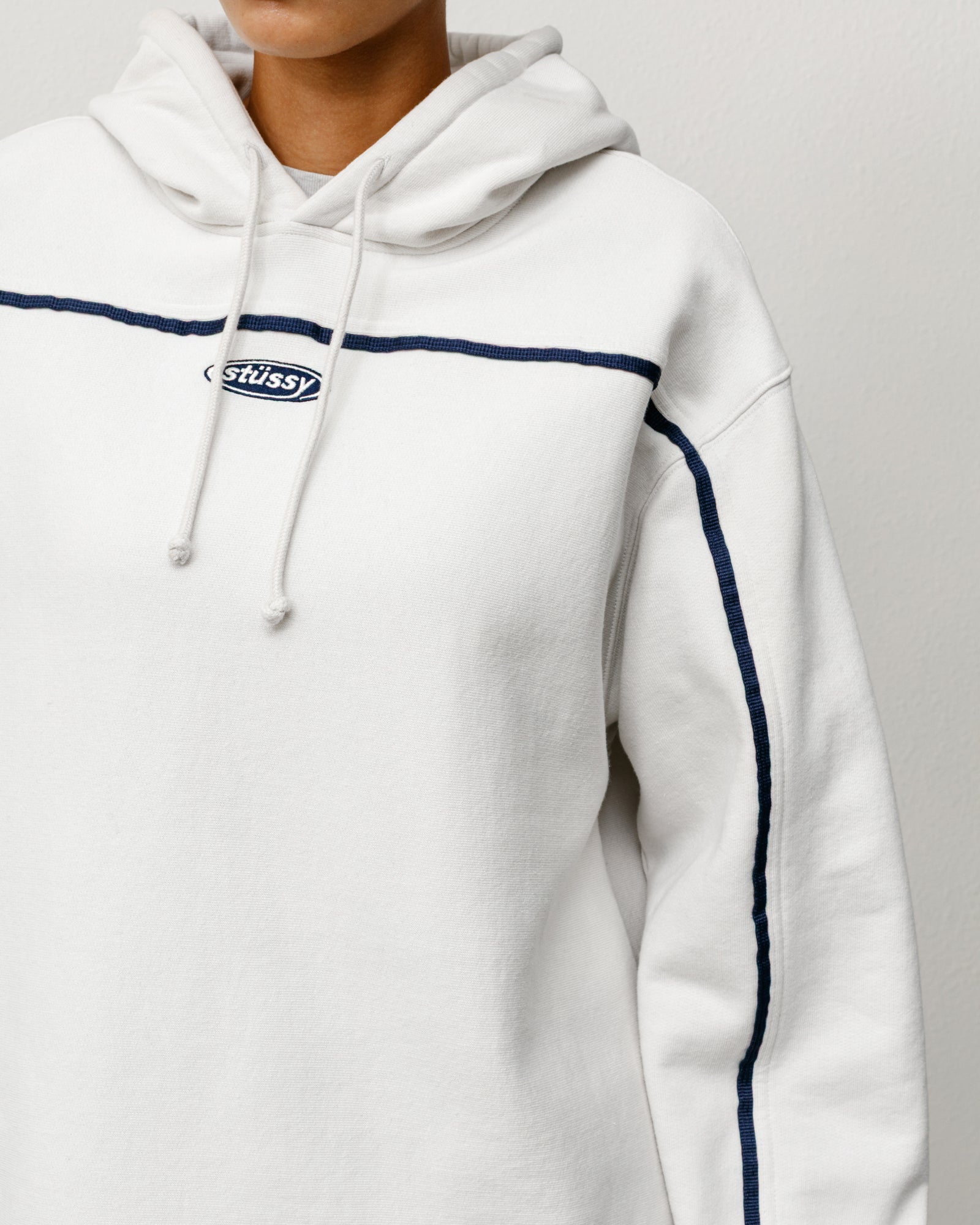 Oval Pullover Hoodie Unisex Long Sleeve In Stone With Navy Chest Piping And Oval Stüssy Logo Embroidery