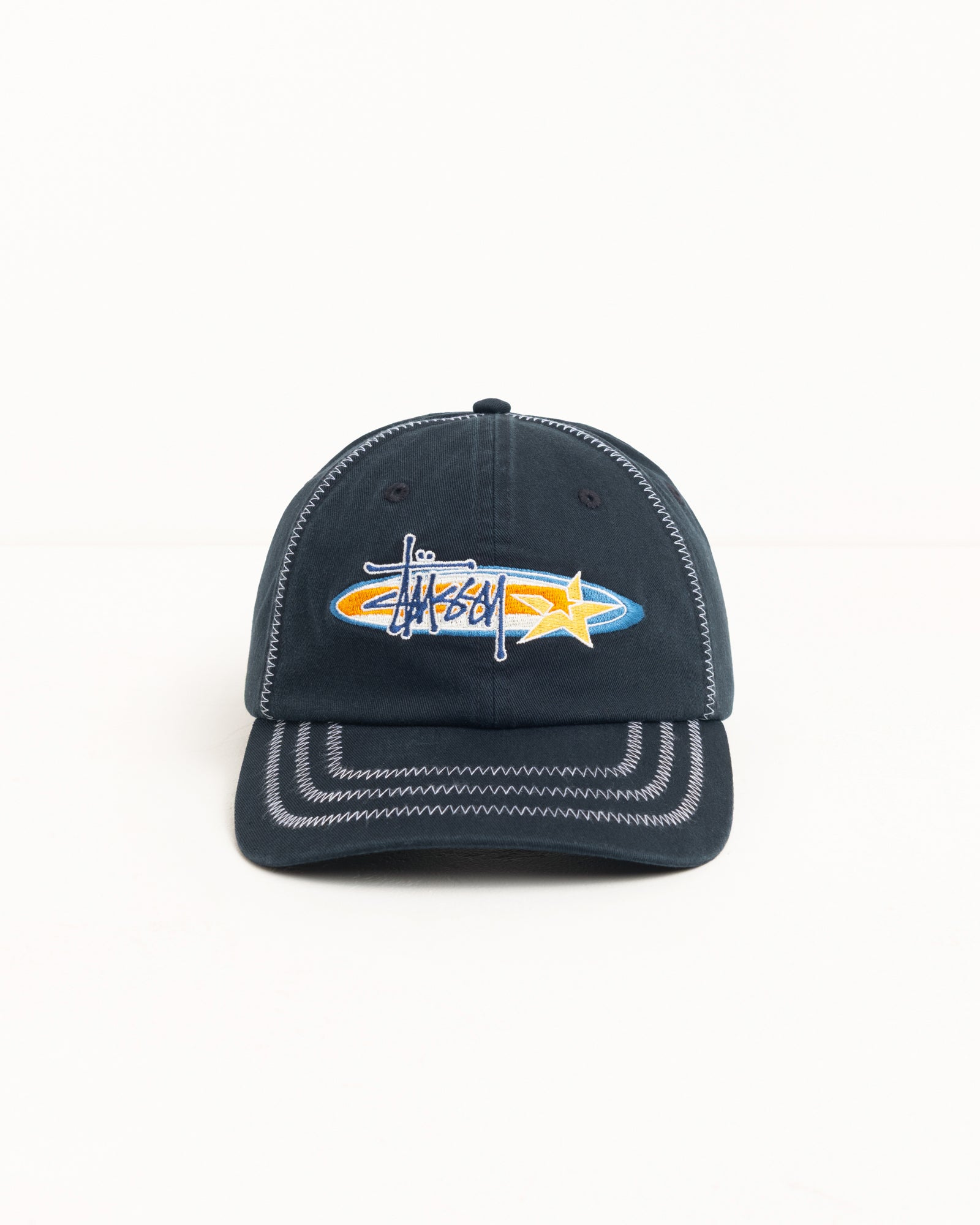 Black six-panel cap with contrast zig-zag stitching and oval star logo embroidery