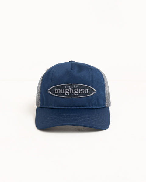 Navy trucker cap with mesh back and raised oval logo patch; precurved brim, unisex.