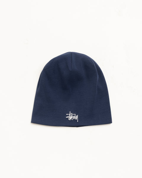 Navy jersey skullcap beanie with white logo embroidery, fitted unisex style