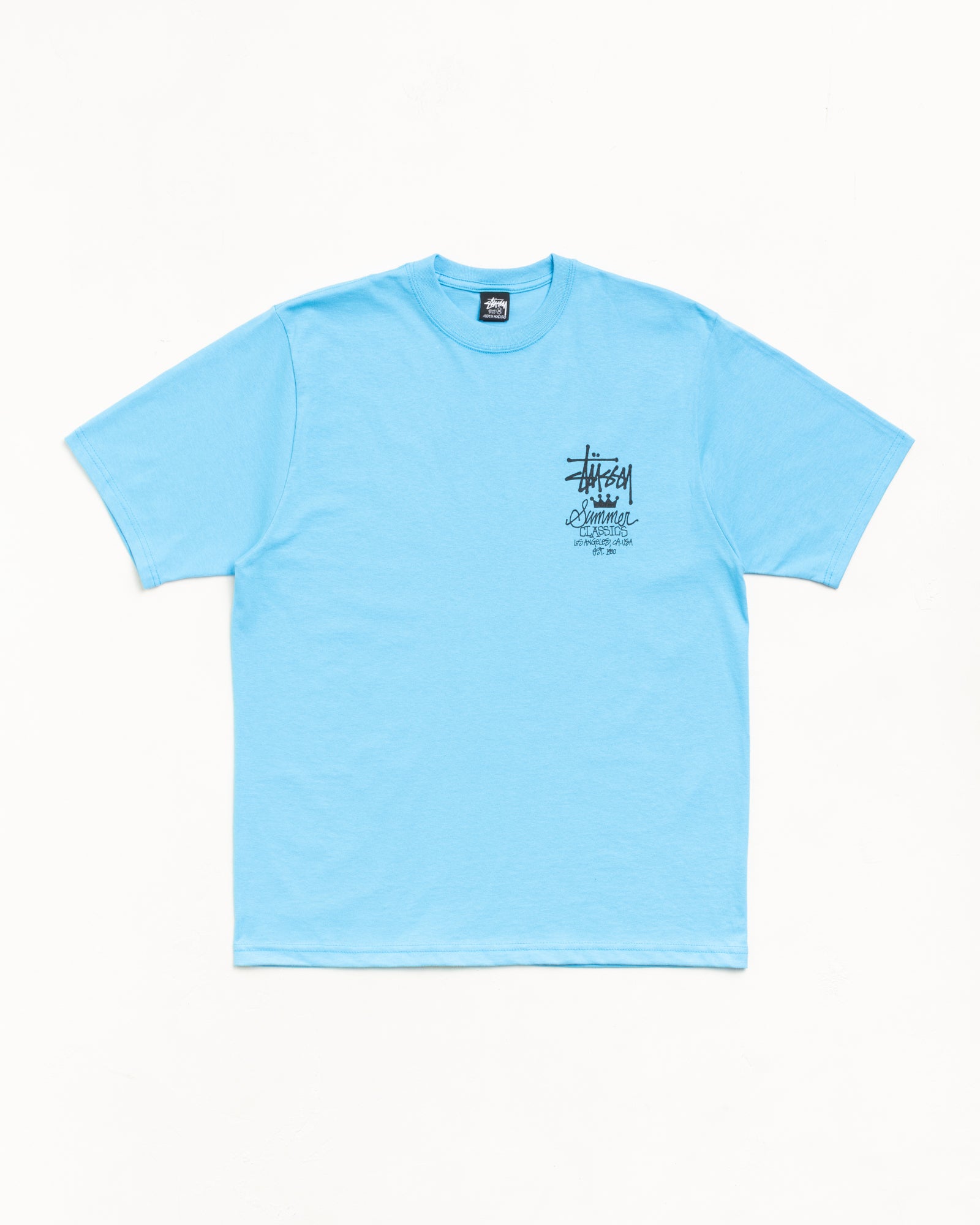Sky blue unisex short-sleeve tee with small black chest logo and crewneck