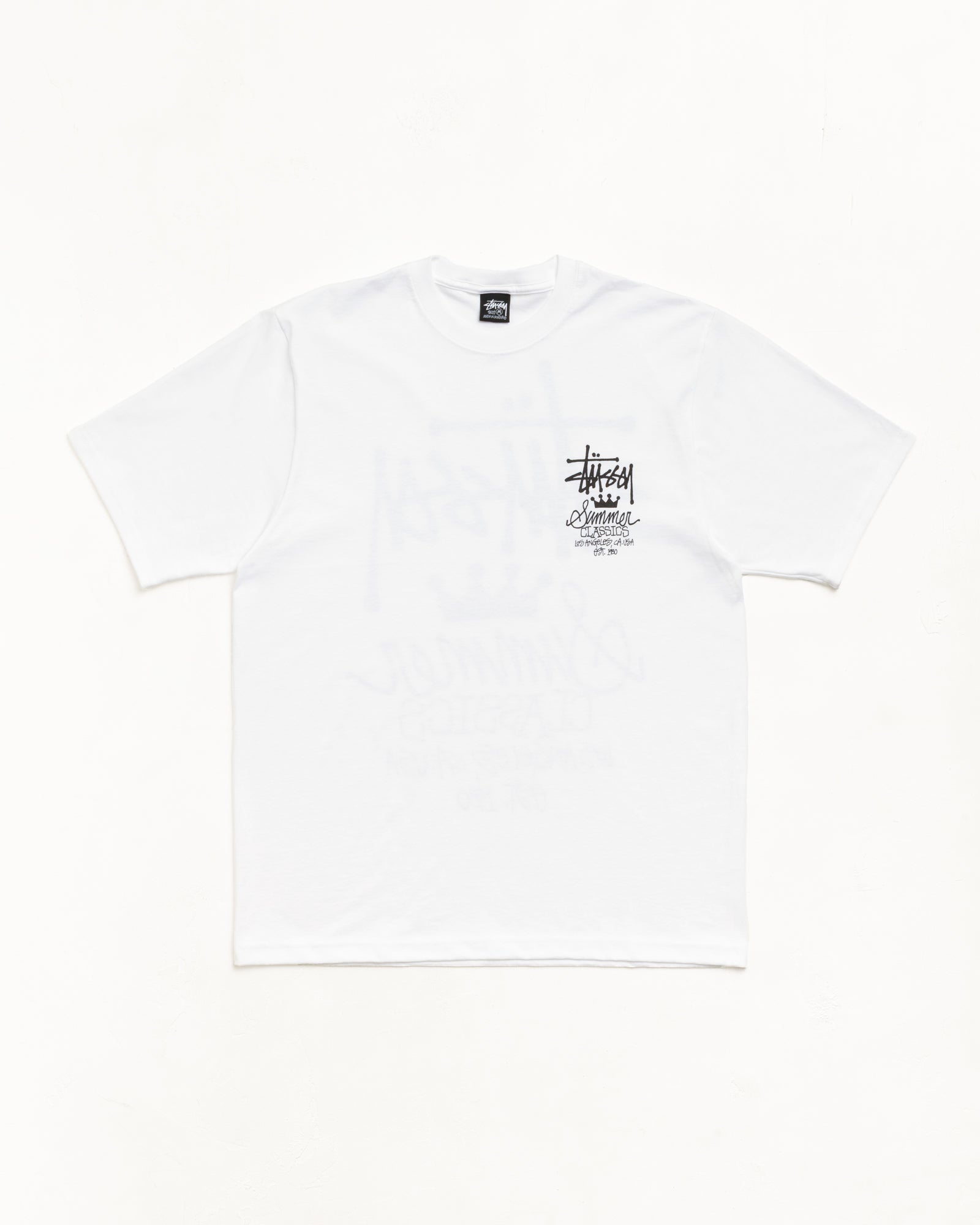White unisex short sleeve tee with small black chest logo and ribbed crewneck