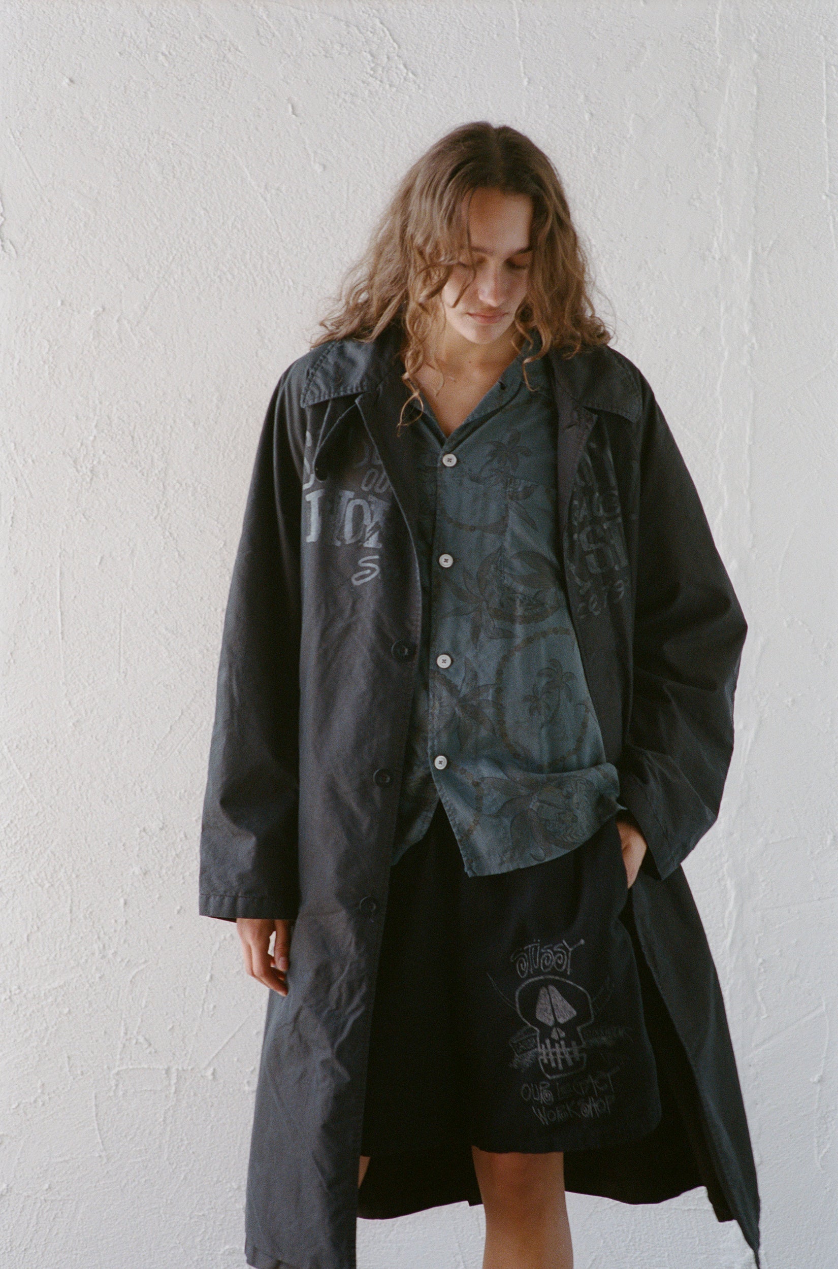 Model wearing the Our Legacy Raglan Car Coat in Overdyed from Stussy & Our Legacy Vol. 10. 